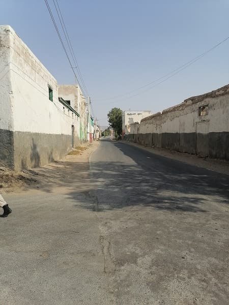 An approach road running between compound walls