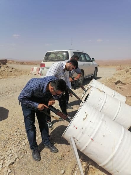 Equipment being handed into an armoured vehicle