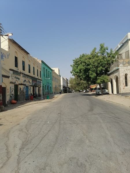 A wide street of low buildings in a coastal town